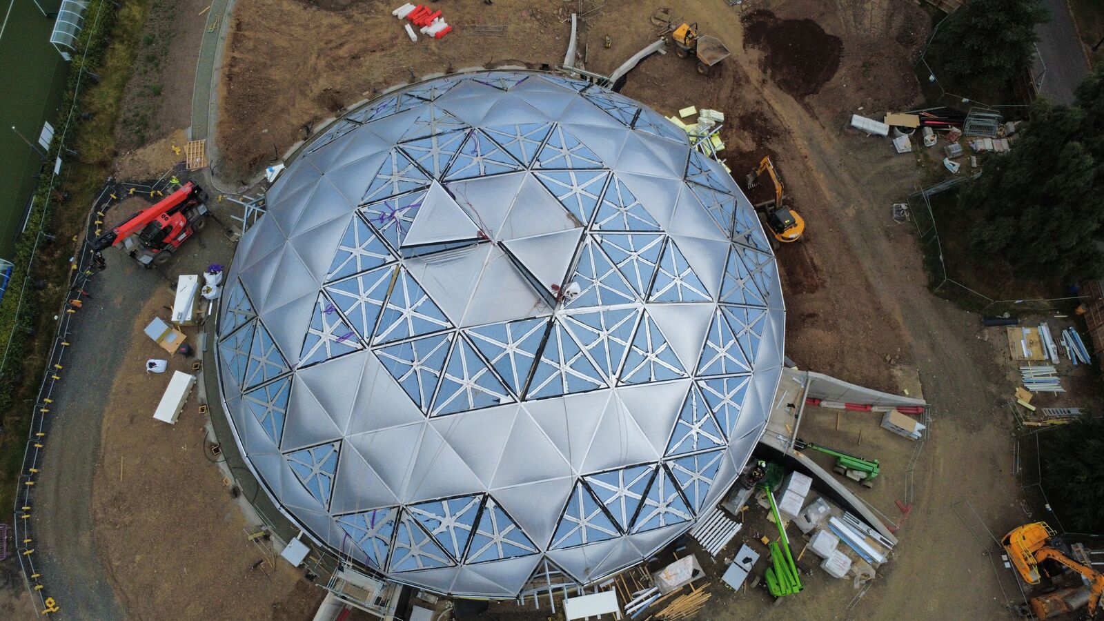 Top-down drone view of a geodesic dome under construction