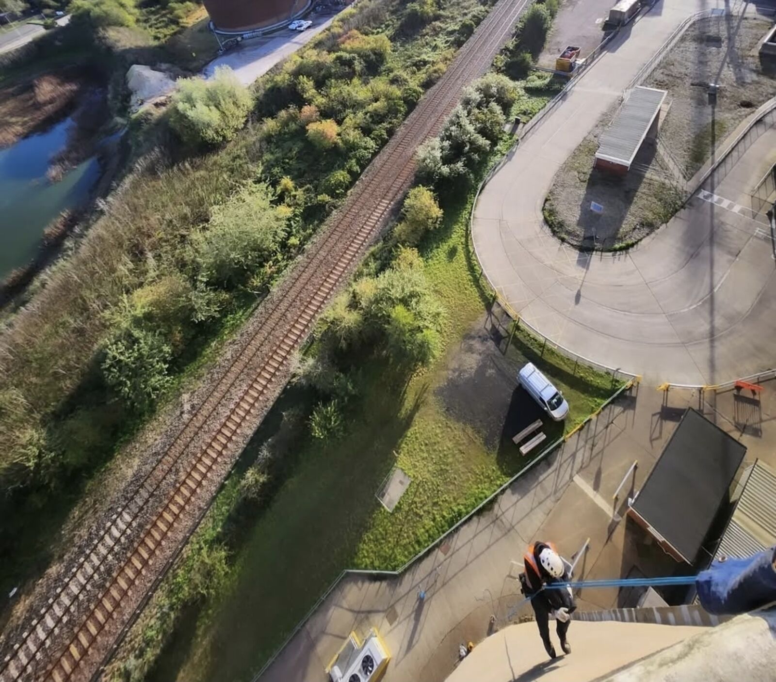 View down an industrial chimney with a rope access technician descending